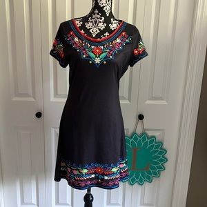 Black polyester dress with fun print around neckline and bottom.
